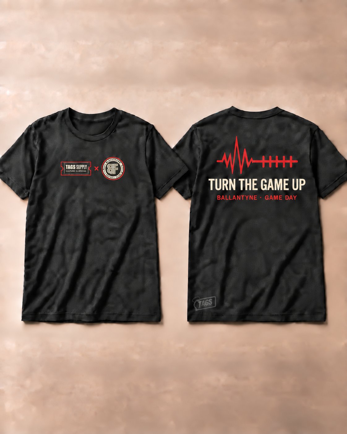 Black tee, front and back. Back reads Turn the game up.